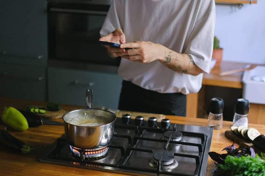 pexels-photo-12673657 A Person Taking Picture of a Pot with Boiling Water